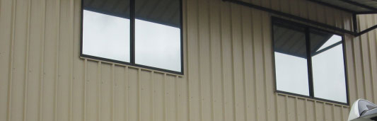 outside view of an office building with two windows tinted