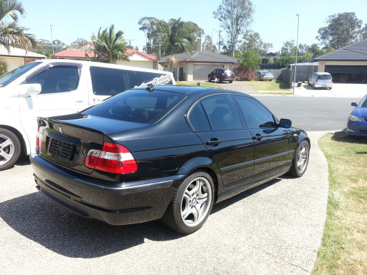 rear view BMW 3 series sedan tinted windows by Optimus Tinting Solutions mobile car window tinting service
