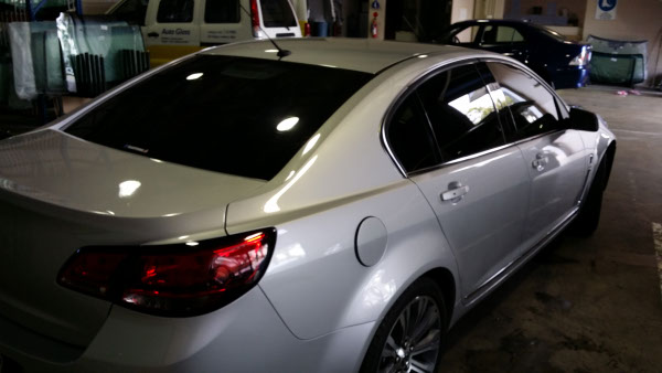rear view silver Holden Commodore sedan rear windscreen glass tinted by Optimus Tinting Solutions Brisbane